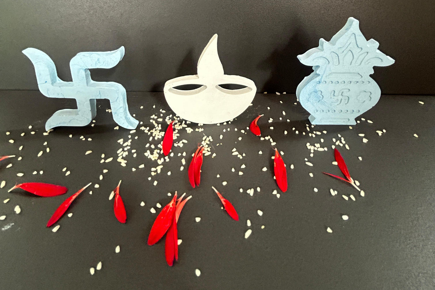 Decorative items including a swastika, Kalash and Diya