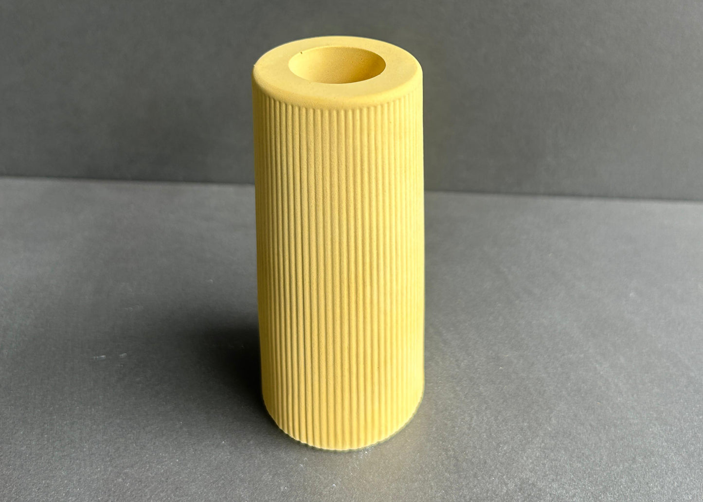 Yellow ribbed concrete cylindrical vase