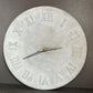 Concrete wall clock with Roman numeral