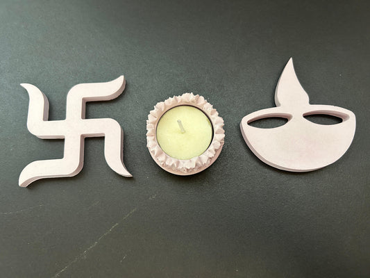 Decorative items including a swastika symbol, a small candle holder, and a Diwali lamp 