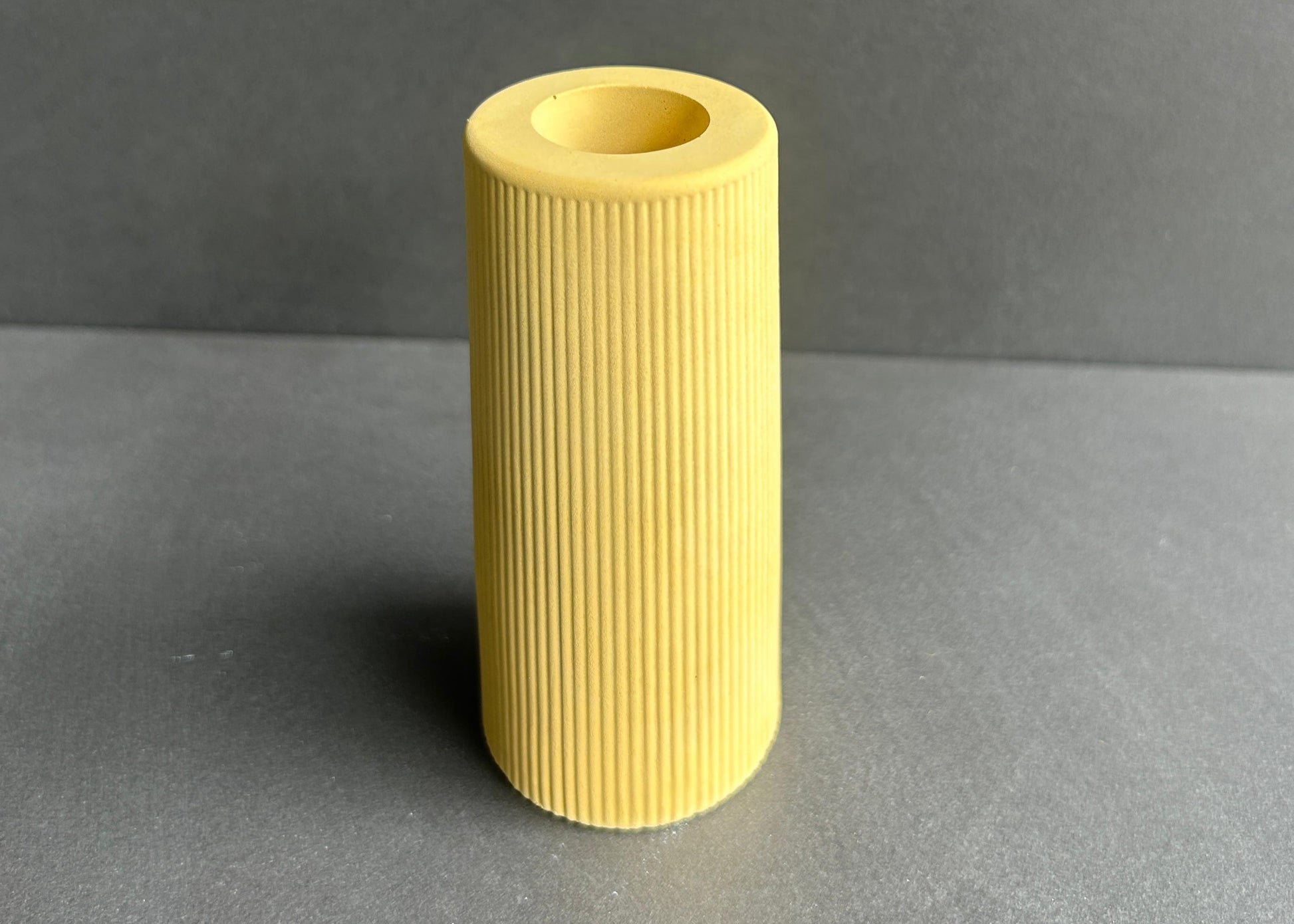 Yellow ribbed concrete cylindrical vase