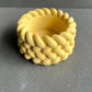 Braided yellow candle holder